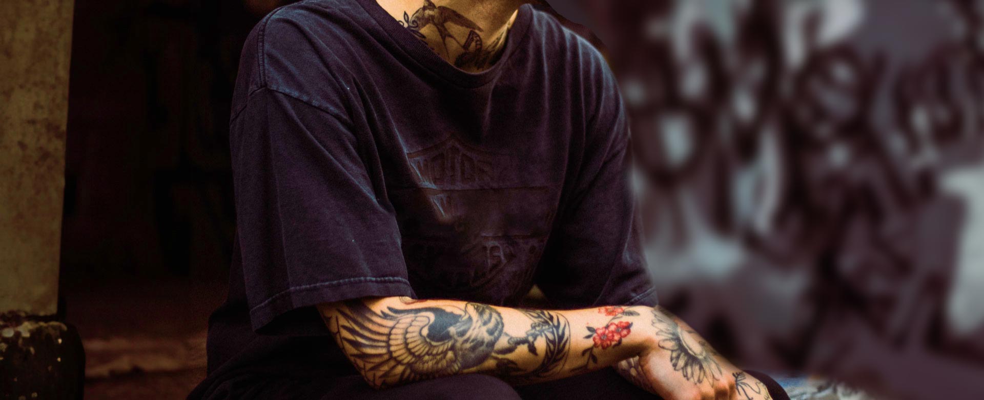 Man with Tattooed Arm and Neck Wearing a T-shirt Man with Tattooed Arm and Neck Wearing a T-shirt